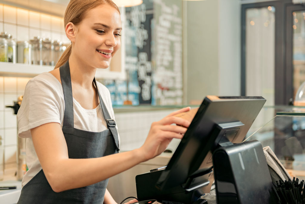 cheerful-shop-assistant-using-digital-device-for-payment-gencare